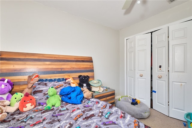 carpeted bedroom featuring a ceiling fan and a closet