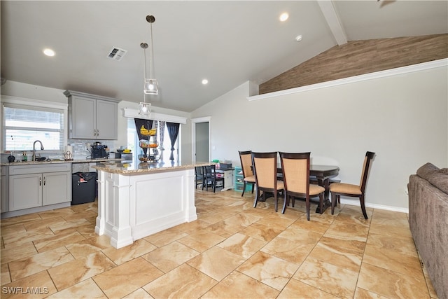 kitchen with a sink, gray cabinets, a kitchen island, beamed ceiling, and recessed lighting