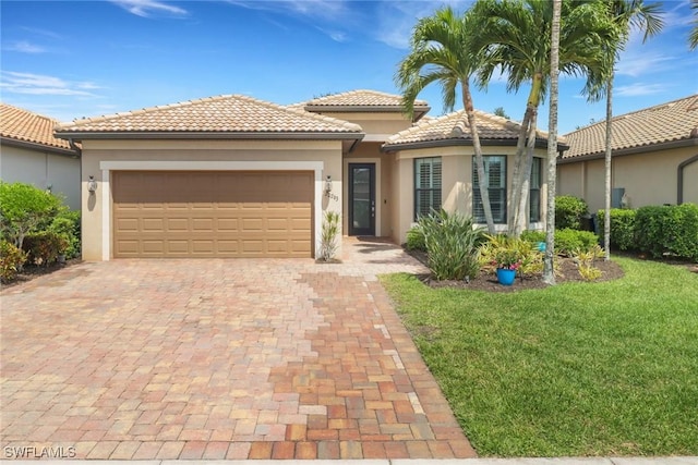 20263 Cypress Shadows Blvd, Estero, FL 33928 - view of front facade with a garage, a tiled roof, stucco siding, a front lawn, and decorative driveway