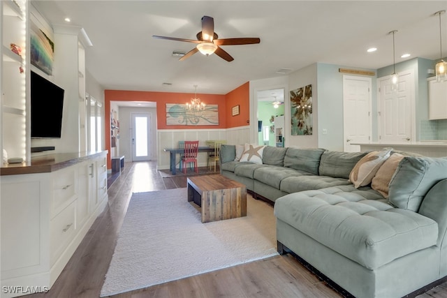 20263 Cypress Shadows Blvd, Estero, FL 33928 - living area with wood finished floors, ceiling fan with notable chandelier, visible vents, wainscoting, and recessed lighting