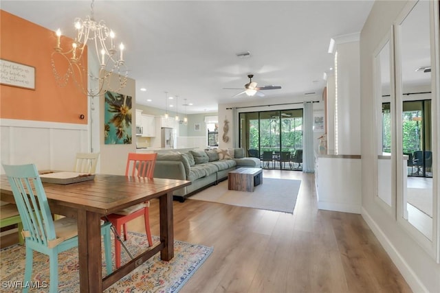 20263 Cypress Shadows Blvd, Estero, FL 33928 - living area featuring a decorative wall, wainscoting, ceiling fan with notable chandelier, and wood finished floors