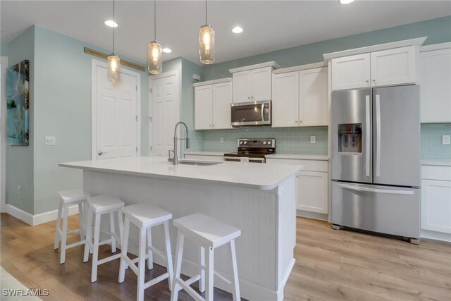 20263 Cypress Shadows Blvd, Estero, FL 33928 - kitchen featuring a sink, stainless steel appliances, decorative backsplash, and light wood-type flooring