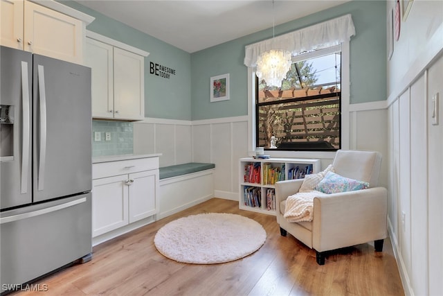 20263 Cypress Shadows Blvd, Estero, FL 33928 - sitting room with wainscoting, light wood-style flooring, a notable chandelier, and a decorative wall