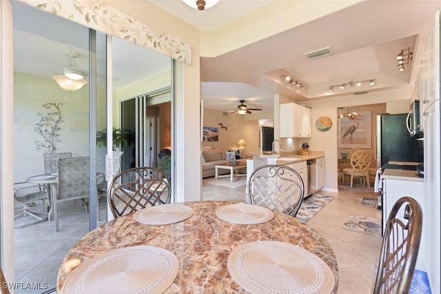 11019 Mill Creek Way Unit 903, Fort Myers, FL 33913 - dining room featuring visible vents, ceiling fan, a raised ceiling, rail lighting, and light tile patterned floors