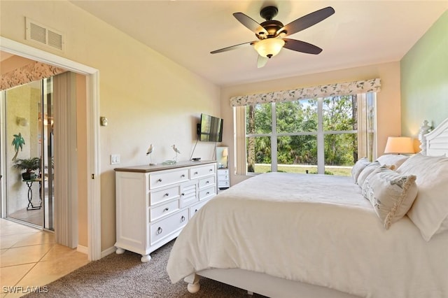 11019 Mill Creek Way Unit 903, Fort Myers, FL 33913 - bedroom featuring ceiling fan, visible vents, light tile patterned floors, baseboards, and light carpet