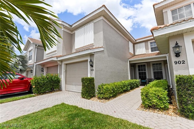 11019 Mill Creek Way Unit 903, Fort Myers, FL 33913 - townhome / multi-family property featuring a garage, stucco siding, driveway, and a tile roof