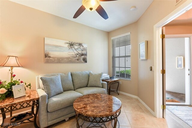 11019 Mill Creek Way Unit 903, Fort Myers, FL 33913 - living area with light tile patterned floors, baseboards, and a ceiling fan