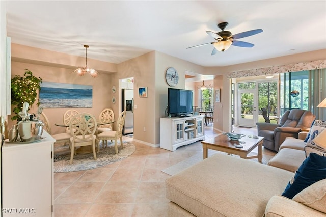 11019 Mill Creek Way Unit 903, Fort Myers, FL 33913 - living room with baseboards, ceiling fan with notable chandelier, and light tile patterned floors