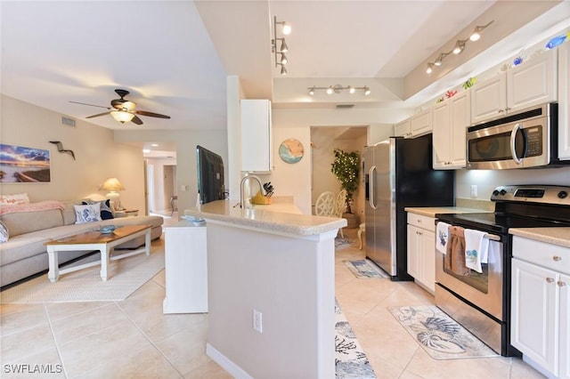 11019 Mill Creek Way Unit 903, Fort Myers, FL 33913 - kitchen featuring a peninsula, open floor plan, a ceiling fan, appliances with stainless steel finishes, and light tile patterned floors