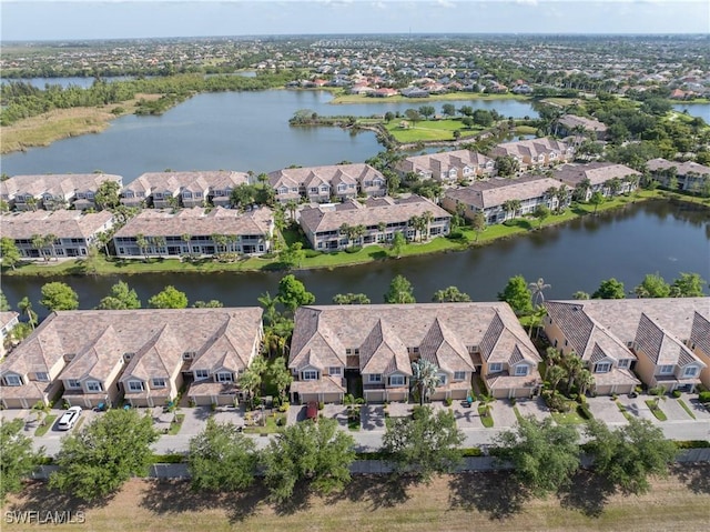 drone / aerial view with a residential view and a water view