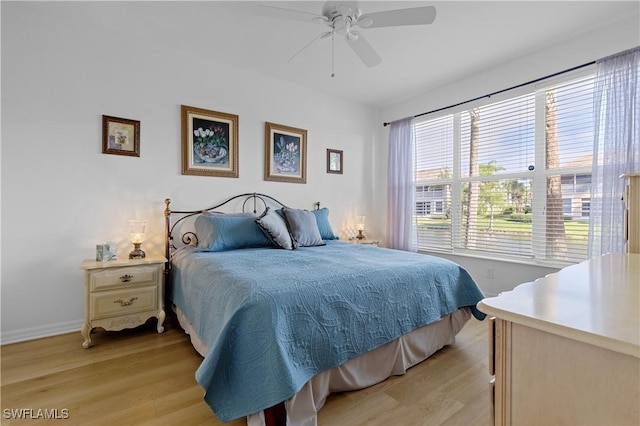 bedroom with baseboards, ceiling fan, and light wood finished floors
