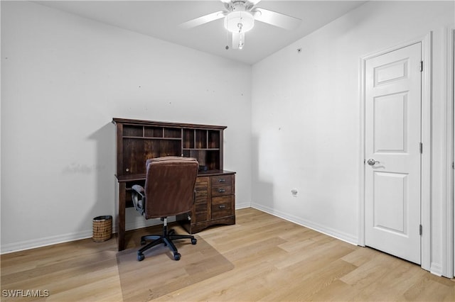 office space with light wood-type flooring, baseboards, and ceiling fan