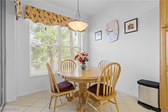 dining area featuring baseboards and light tile patterned floors