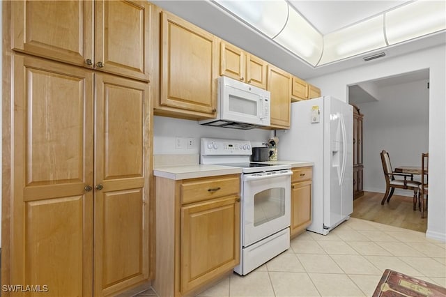 kitchen featuring visible vents, light brown cabinets, white appliances, light countertops, and light tile patterned floors