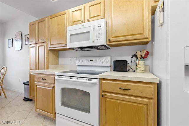 kitchen featuring light countertops, light brown cabinets, light tile patterned floors, and white appliances