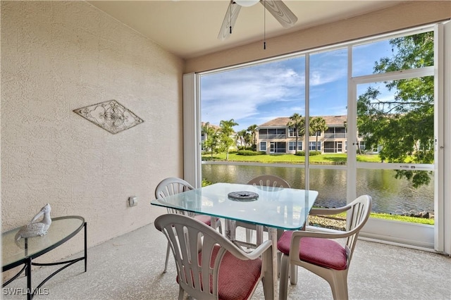 sunroom featuring a water view and plenty of natural light