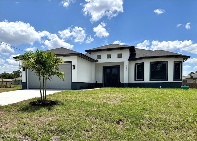 prairie-style home with an attached garage, stucco siding, a front yard, concrete driveway, and french doors