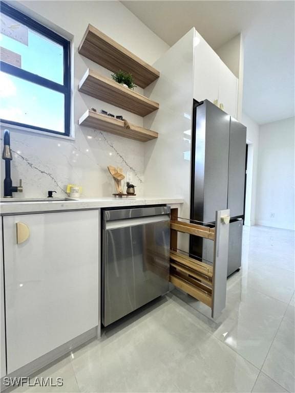 bar with stainless steel appliances, decorative backsplash, a sink, and a dry bar