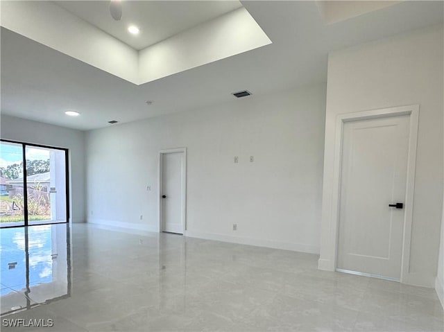 unfurnished room featuring baseboards and visible vents