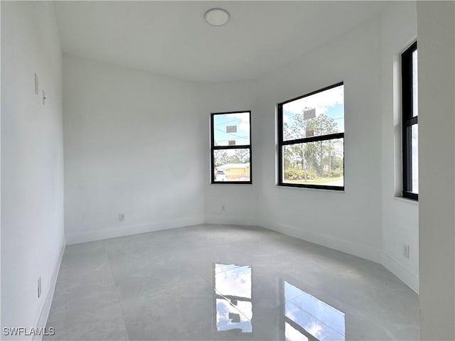 unfurnished room featuring baseboards