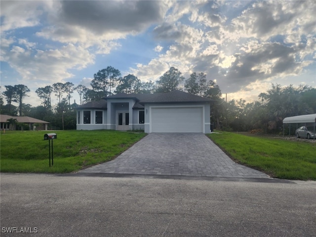 view of front of house with french doors, decorative driveway, a front lawn, an attached garage, and stucco siding