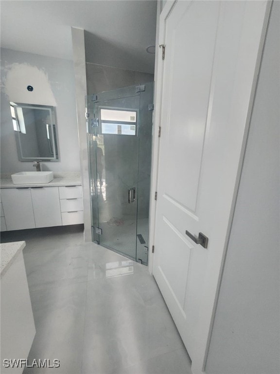 full bathroom featuring finished concrete flooring, vanity, and a shower stall