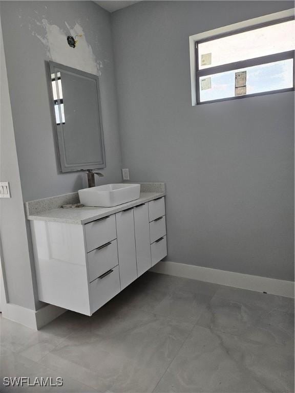 bathroom with baseboards and vanity