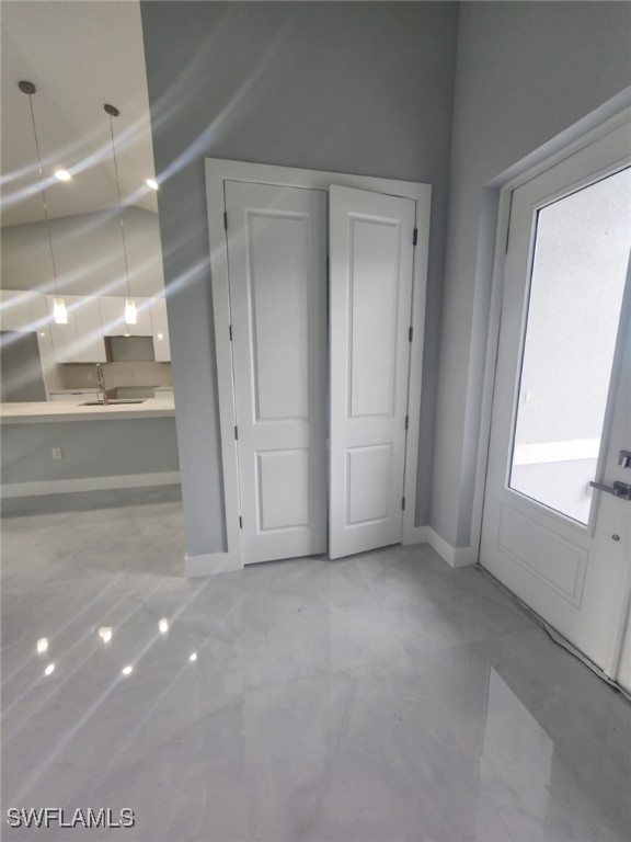 interior space with a sink and baseboards