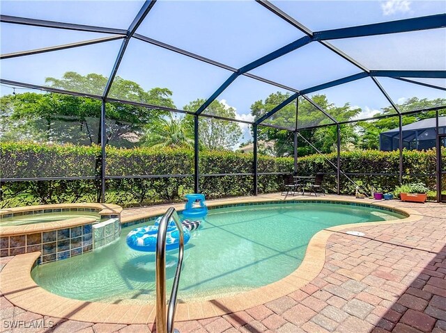 2846 Via Piazza Loop, Fort Myers, FL 33905 - view of swimming pool with glass enclosure, a patio, and a pool with connected hot tub