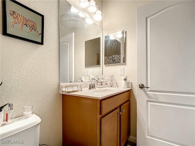2846 Via Piazza Loop, Fort Myers, FL 33905 - bathroom featuring vanity, a textured wall, and toilet
