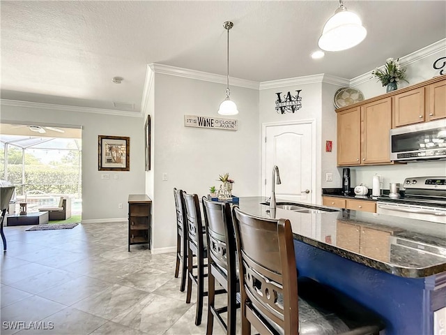 2846 Via Piazza Loop, Fort Myers, FL 33905 - kitchen featuring crown molding, a breakfast bar, a sink, dark stone countertops, and stainless steel appliances
