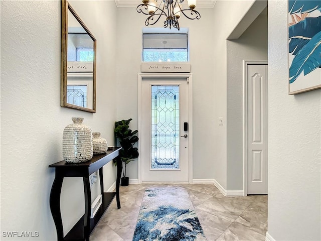 2846 Via Piazza Loop, Fort Myers, FL 33905 - foyer featuring crown molding, baseboards, a chandelier, and a textured wall