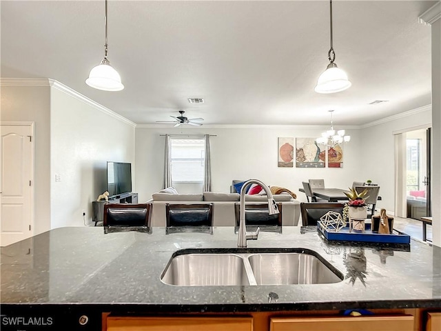 2846 Via Piazza Loop, Fort Myers, FL 33905 - kitchen with a sink, crown molding, a center island with sink, and open floor plan