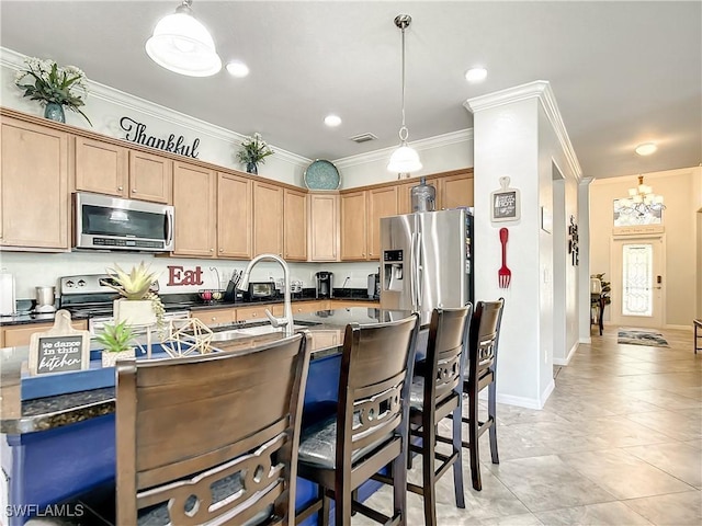 2846 Via Piazza Loop, Fort Myers, FL 33905 - kitchen with dark countertops, appliances with stainless steel finishes, an inviting chandelier, a breakfast bar area, and ornamental molding
