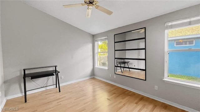 17942 Oakmont Ridge Cir, Fort Myers, FL 33967 - empty room with wood finished floors, vaulted ceiling, a ceiling fan, and baseboards