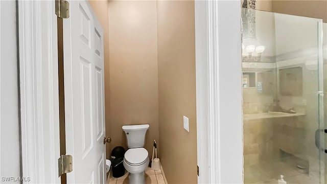 17942 Oakmont Ridge Cir, Fort Myers, FL 33967 - full bathroom featuring a shower stall, toilet, tile patterned floors, and baseboards