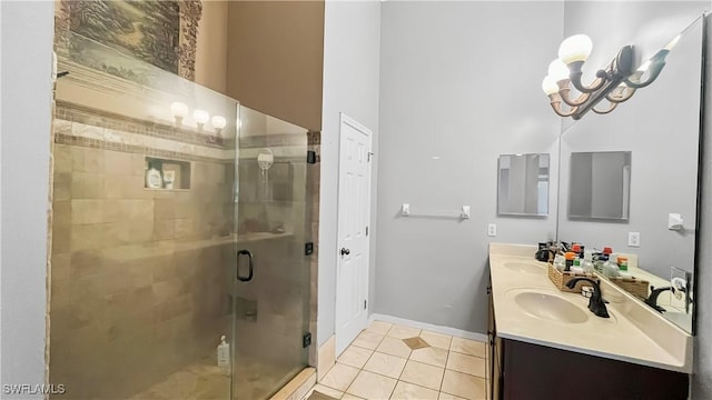 17942 Oakmont Ridge Cir, Fort Myers, FL 33967 - bathroom featuring tile patterned floors, double vanity, a shower stall, a chandelier, and baseboards