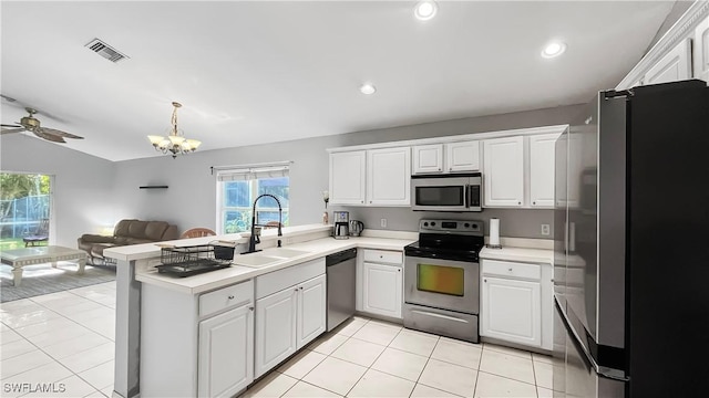 17942 Oakmont Ridge Cir, Fort Myers, FL 33967 - kitchen featuring appliances with stainless steel finishes, a sink, a peninsula, light countertops, and vaulted ceiling