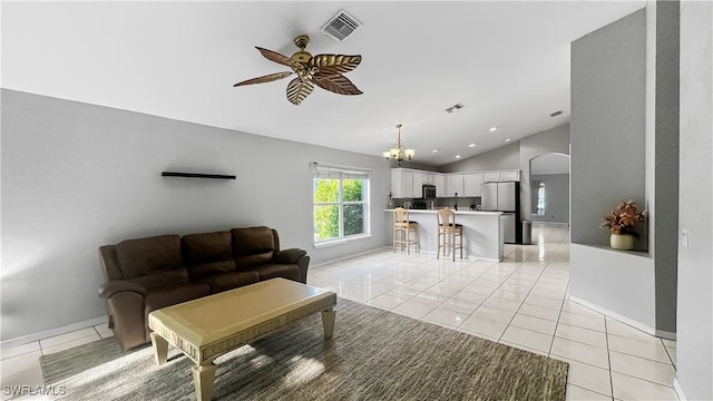 17942 Oakmont Ridge Cir, Fort Myers, FL 33967 - living room featuring vaulted ceiling, a ceiling fan, a chandelier, arched walkways, and light tile patterned floors