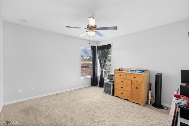 bedroom featuring light carpet, baseboards, and a ceiling fan