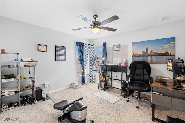 carpeted home office featuring baseboards and ceiling fan
