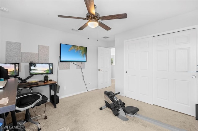 carpeted home office with a ceiling fan, baseboards, and visible vents