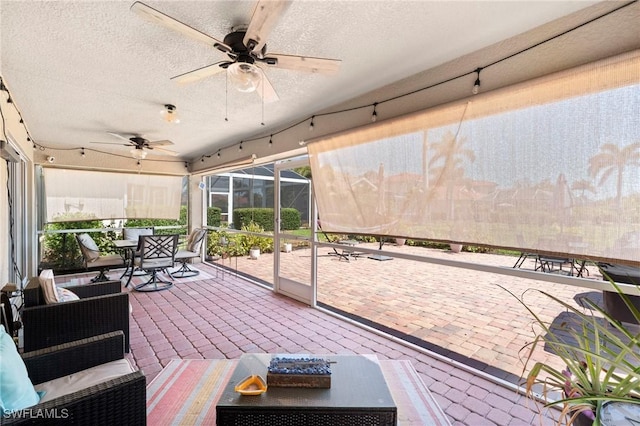 exterior space with ceiling fan and glass enclosure