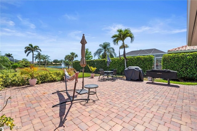 view of patio / terrace featuring a water view and area for grilling