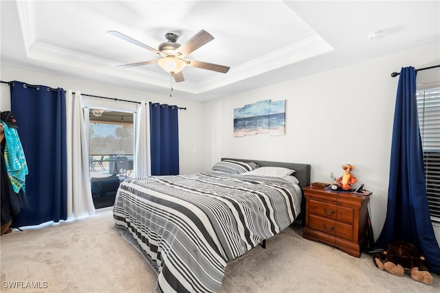carpeted bedroom featuring a ceiling fan, a raised ceiling, ornamental molding, and access to exterior