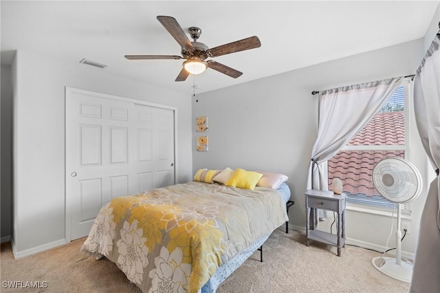 bedroom with light colored carpet, baseboards, a closet, and visible vents