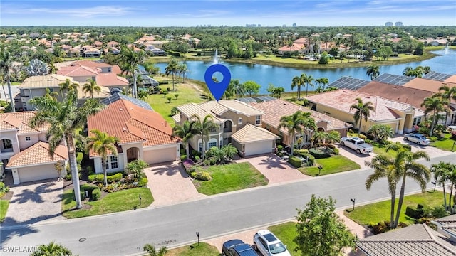bird's eye view with a water view and a residential view
