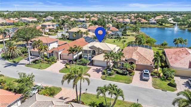 drone / aerial view with a water view and a residential view