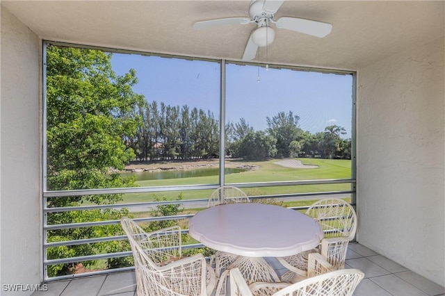 balcony with a water view and ceiling fan