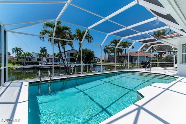 931 Snowberry Ct, Marco Island, FL 34145 - outdoor pool with glass enclosure, a patio, grilling area, and a water view